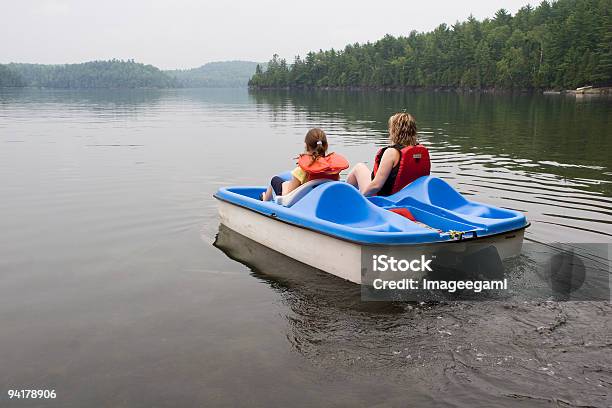 A Mother And Daughter Riding A Pedelo Wearing Life Jackets Stock Photo - Download Image Now