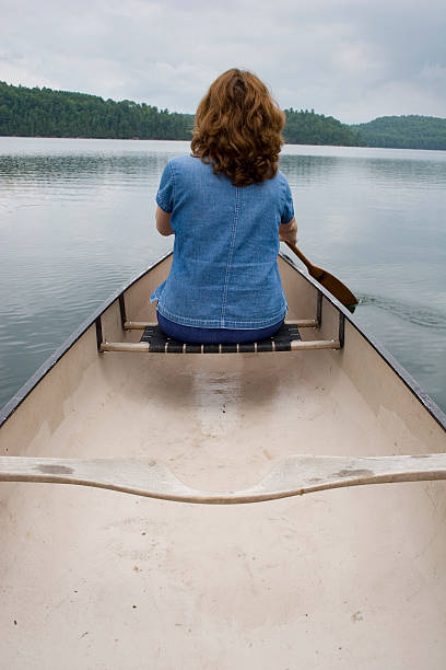 istock Woman canoeing on a lake 94178911