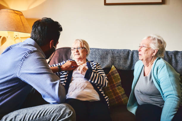 istock Doctor on home visit examining senior female 941789544