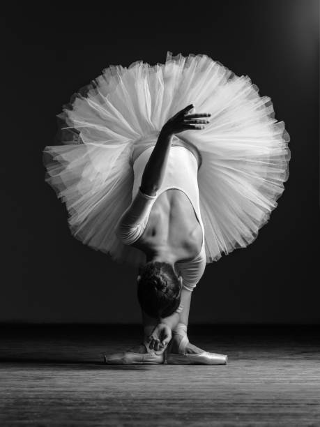 istock Young beautiful ballerina posing in studio 941789750
