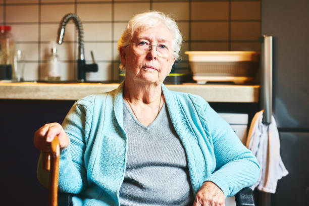 Senior woman sitting in kitchen