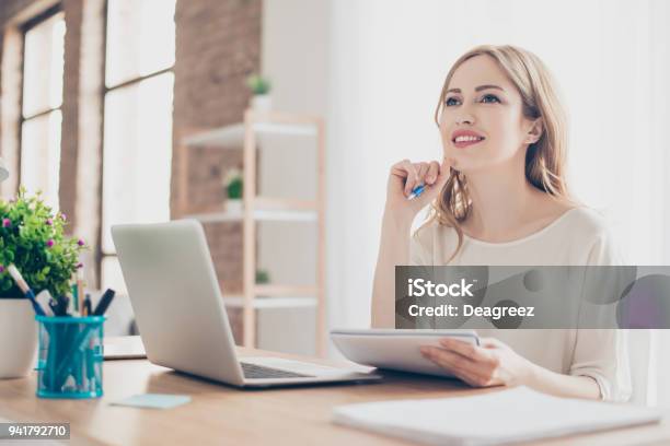 Portrait Of Young Beautiful Thoughtful Lady Sitting At The Table Working With Laptop On Writing Down New Ideas Stock Photo - Download Image Now