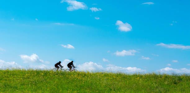 istock bicycle silhouettes on the dyke 941792746