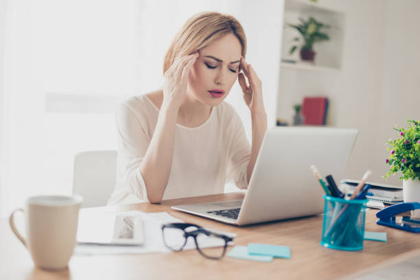 istock Overworked businesswoman suffering from headache and thinking how to end project 941793532