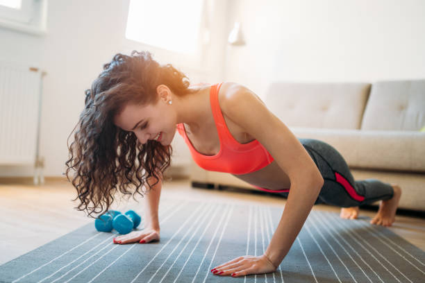 istock Young attractive sportswoman doing exercises at home 941796052