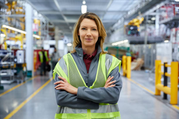 Mature female engineer standing with arms crossed