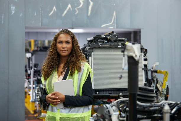 istock Young female engineer holding document at factory 941796714