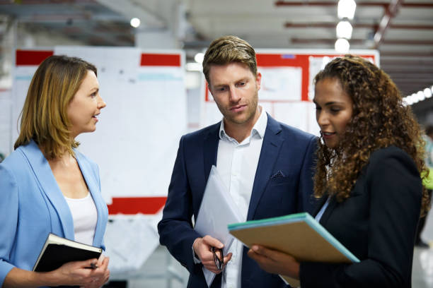 istock Multi-ethnic colleagues discussing at factory 941797394