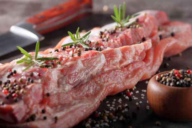 istock Raw ribs with spices on stone background 941797886