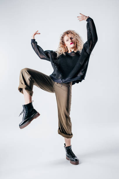 istock Young beautiful female dancer is posing in the studio 941803870