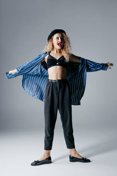 istock Young beautiful female dancer is posing in the studio 941804142