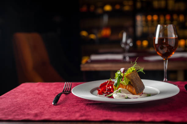 istock restaurant salmon with wine. red cloth 941804678
