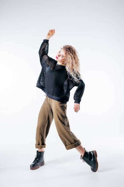 istock Young beautiful female dancer is posing in the studio 941806948
