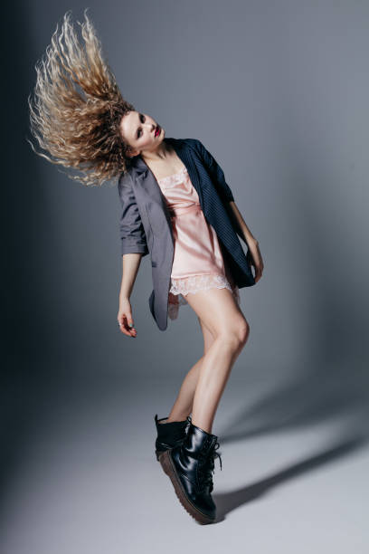 istock Young beautiful female dancer is posing in the studio 941807438