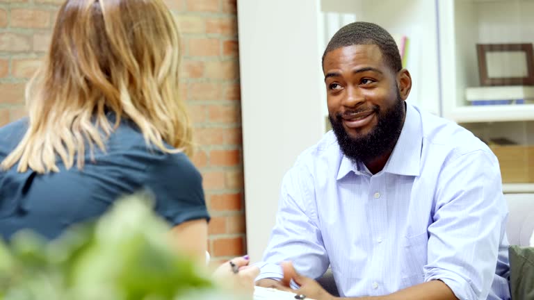 Mid adult African American man talks with mental health professional