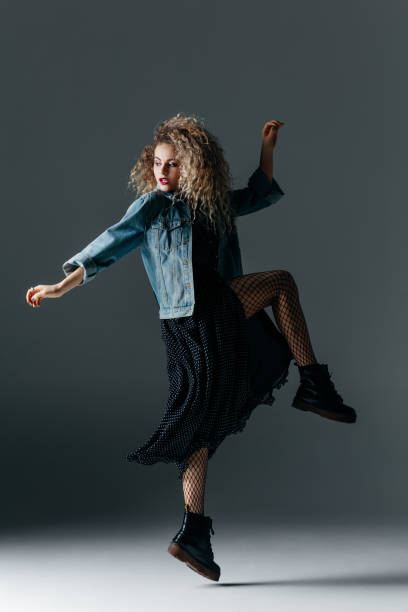 istock Young beautiful female dancer is posing in the studio 941808296