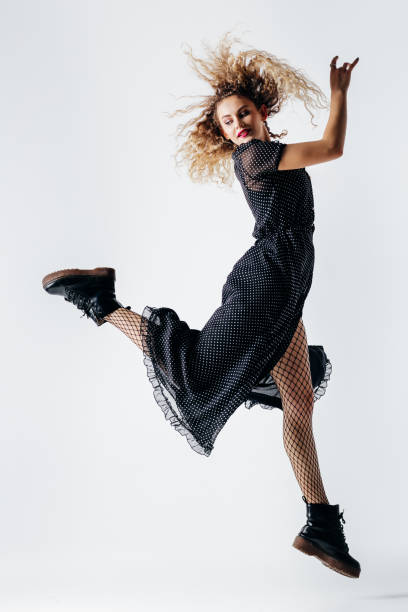 istock Young beautiful female dancer is posing in the studio 941808434