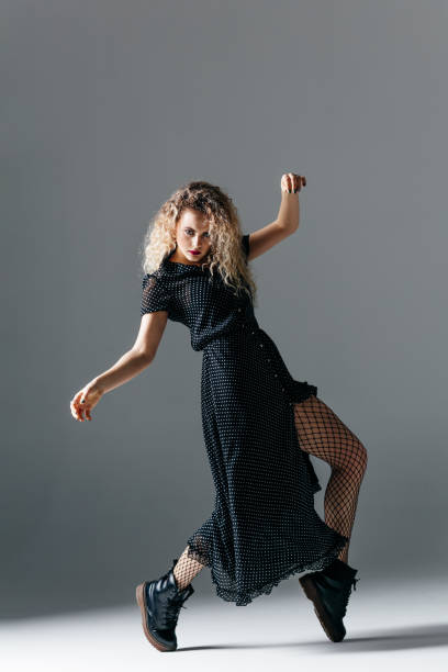 istock Young beautiful female dancer is posing in the studio 941808570