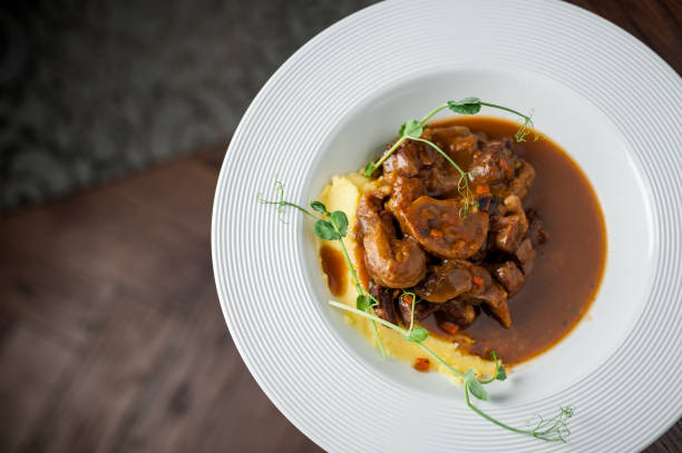 istock the main meat dish on a large deep plate. Restaurant 941808894