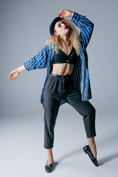 istock Young beautiful female dancer is posing in the studio 941808926