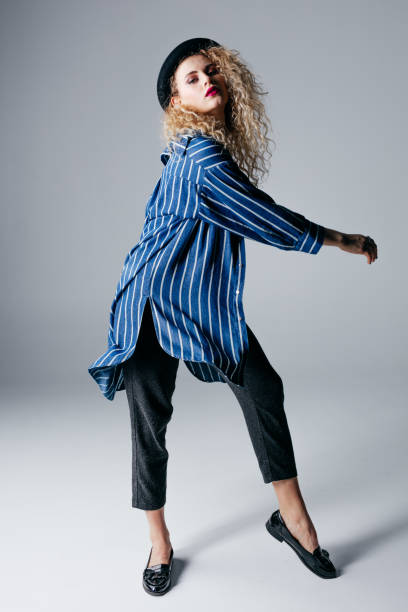 istock Young beautiful female dancer is posing in the studio 941809316
