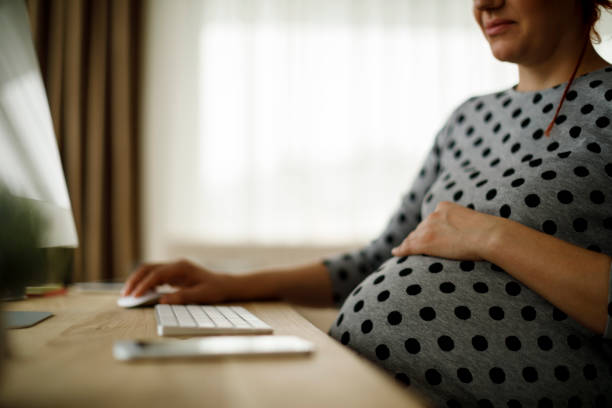 istock Pregnant woman working from home office 941811538