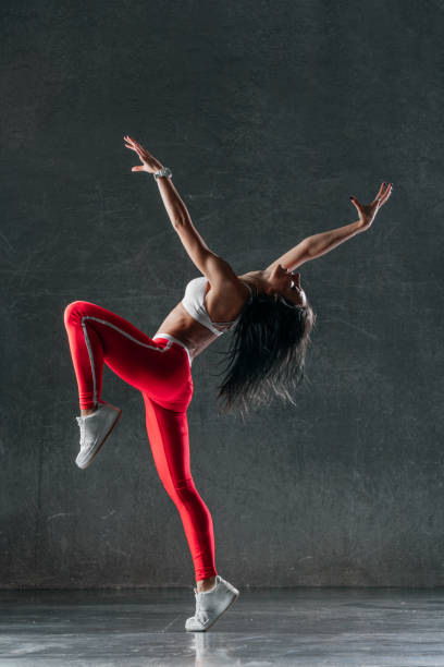 istock Young beautiful female dancer is posing in the studio 941812032