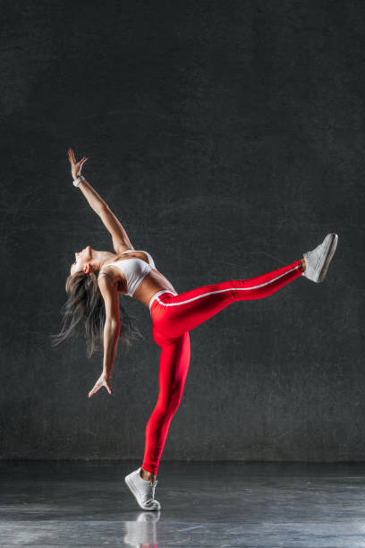 istock Young beautiful female dancer is posing in the studio 941812536