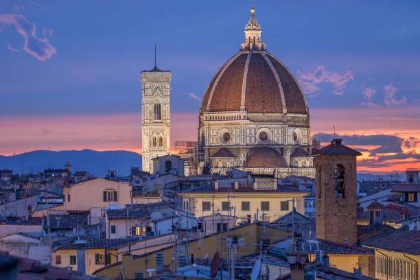 Dome and bell tower of Santa Maria del Fiore cathedral at Florence, Italy Cupola and bell tower of cathedral Santa Maria del Fiore in Florence, Itlay. Church iluminated by lights in the dusk. Beautiful pink and blue sky. michelangelo italy art david stock pictures, royalty-free photos & images