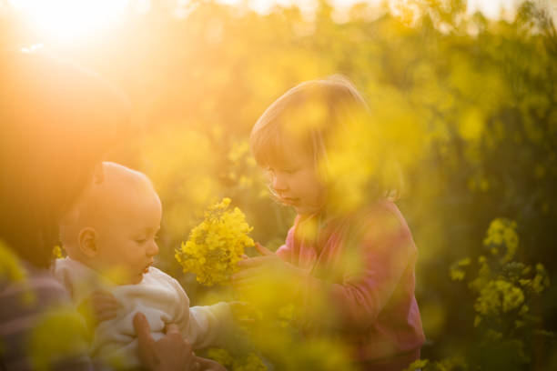 istock Young mother with kids in rapeseed field 941812936