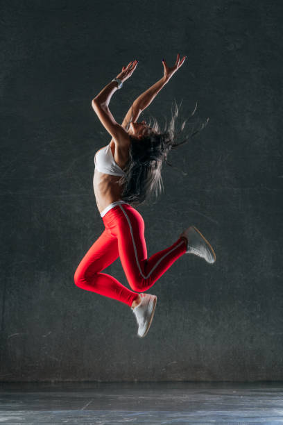 istock Young beautiful female dancer is posing in the studio 941818414