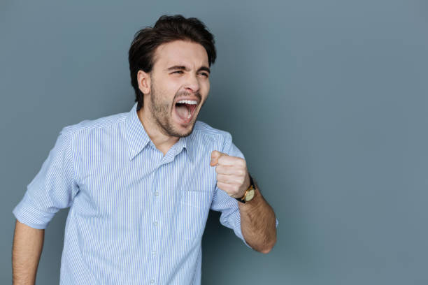 istock Joyful talented man signing a song 941821482