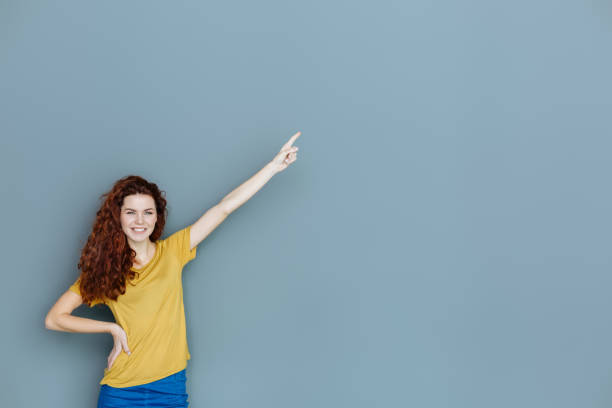 istock Happy delighted woman pointing with her hand 941821600