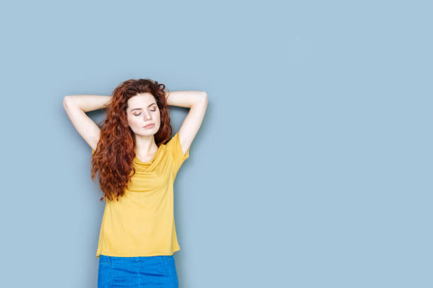 istock Delighted nice woman closing her eyes 941822692