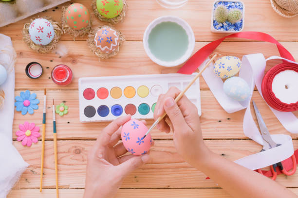 istock Happy easter! A woman hand painting Easter eggs. Happy family preparing for Easter. 941822862