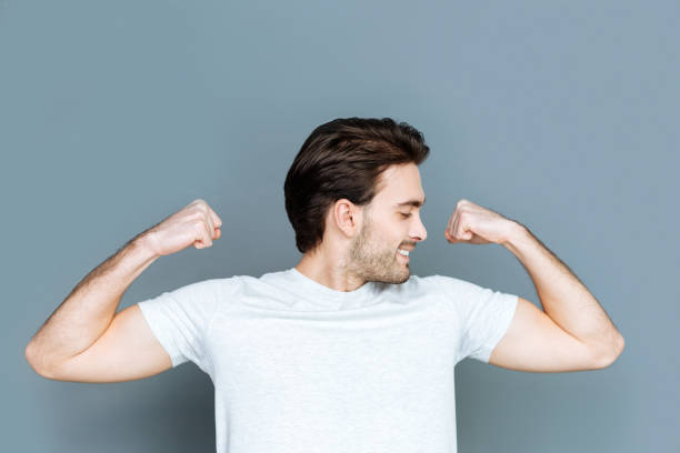 istock Attractive strong man showing his biceps 941825872