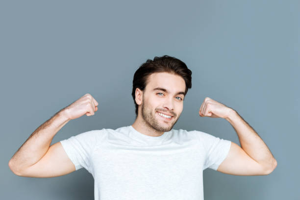 istock Joyful well built man showing his body 941825914