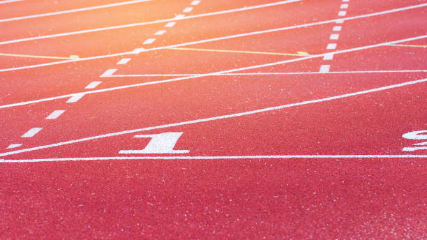 istock Empty Red Running track texture with lane number one, 1st for background copy space, nobody runner tracks athietic competition in sunny day. 941826996