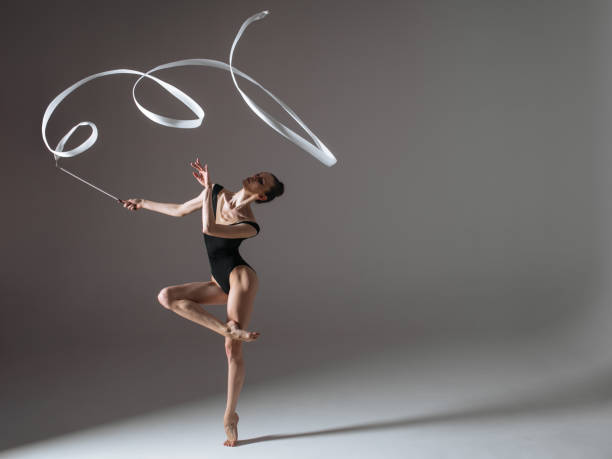 istock Young gymnast woman stretching and training 941835054