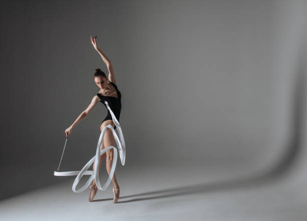 istock Young gymnast woman stretching and training 941835368