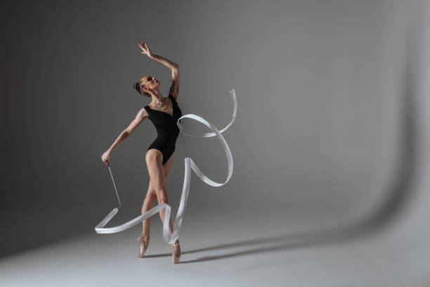 istock Young gymnast woman stretching and training 941835398