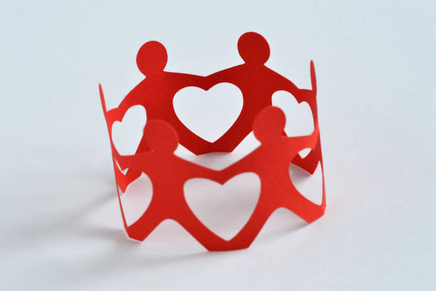 istock Paper people in a circle holding hands - Teamwork and love concept 941837420