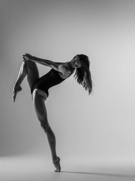 istock Young gymnast woman stretching and training 941838012
