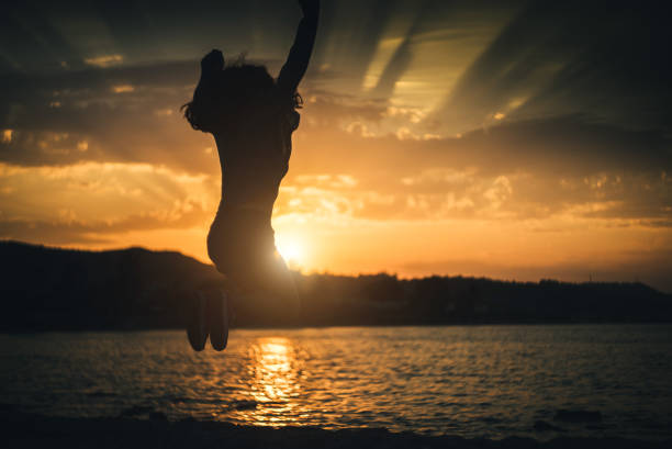 istock Jump of joy at sunset. 941838112