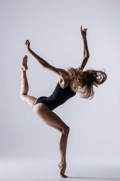 istock Young gymnast woman stretching and training 941838206