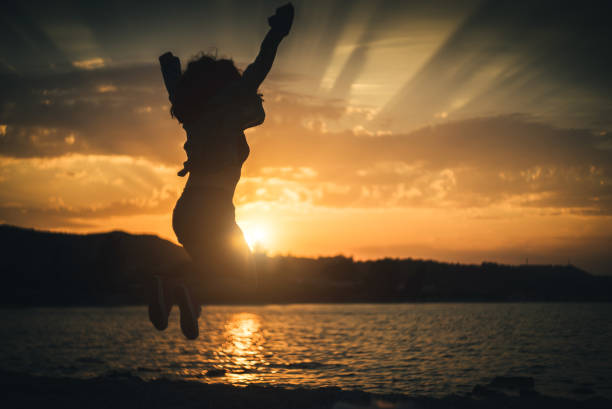 istock Jump of joy at sunset. 941838392