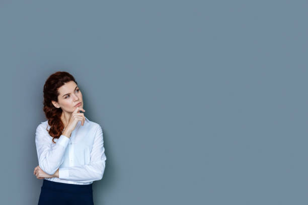 istock Pleasant thoughtful woman looking for new ideas 941838546