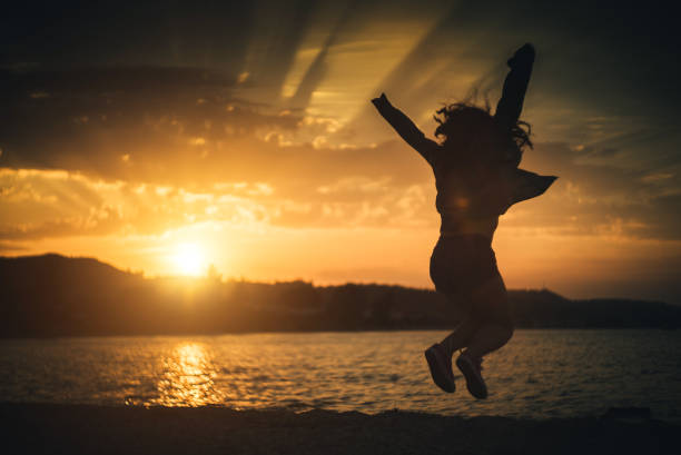 istock Jump of joy at sunset. 941838550