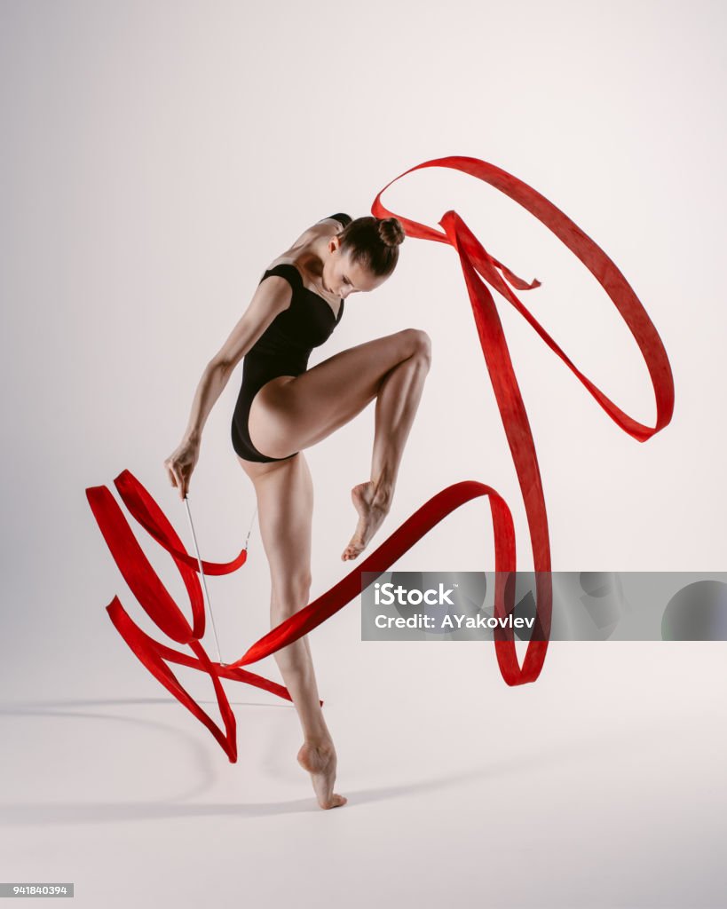 Young gymnast woman stretching and training Flexible female doing acrobatic exercises Gymnastics Stock Photo