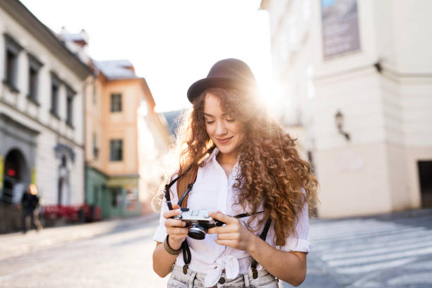 istock Young tourist with camera in the old town. 941841566